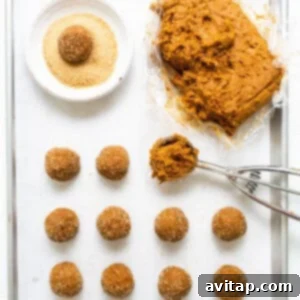Warm Spiced Pumpkin Ginger Molasses Cookies 12 A baking sheet with a tray of doughnuts and a spatula.