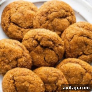 Warm Spiced Pumpkin Ginger Molasses Cookies 9 Ginger cookies on a plate with a fork.