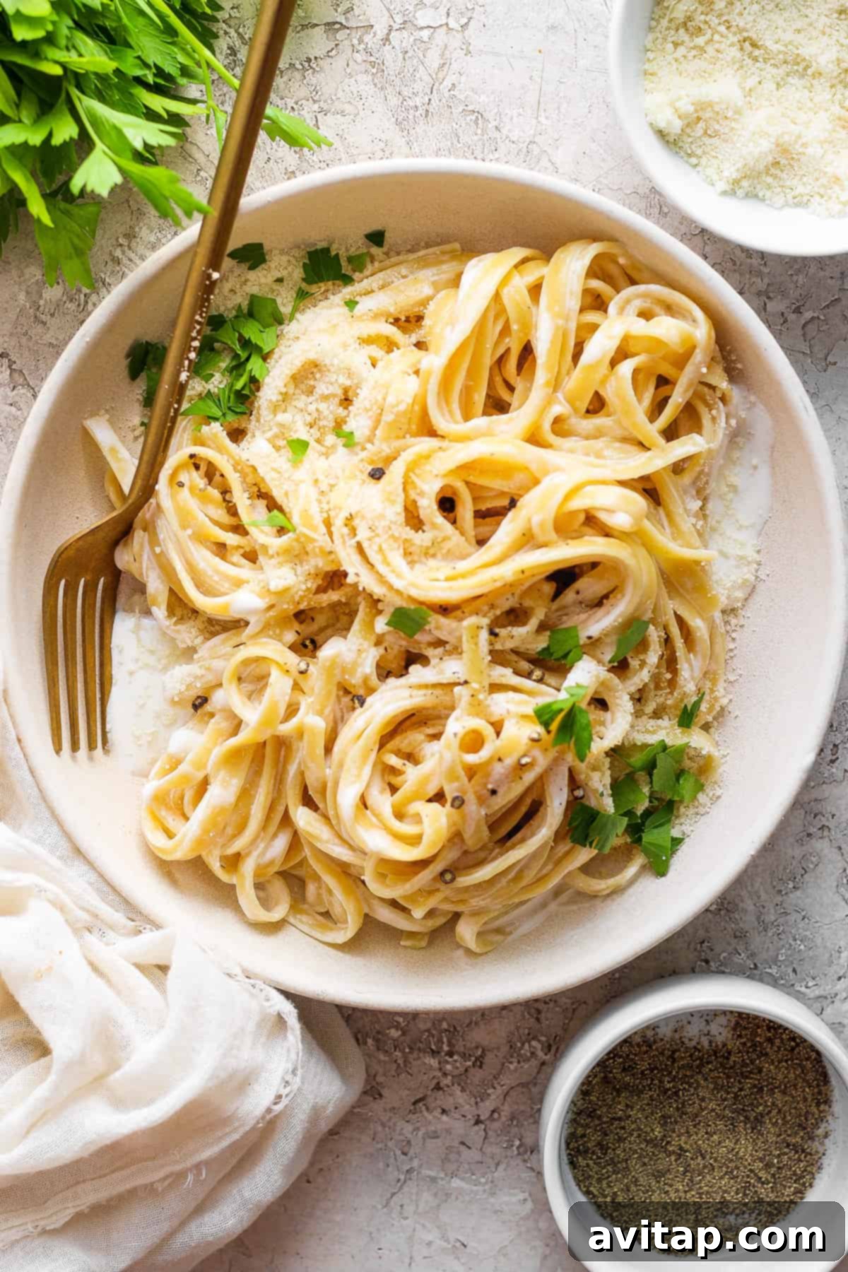 Creamy Cottage Cheese Alfredo 7 A fresh bowl of high-protein cottage cheese Alfredo pasta, garnished with a sprinkle of parmesan cheese and fresh parsley.