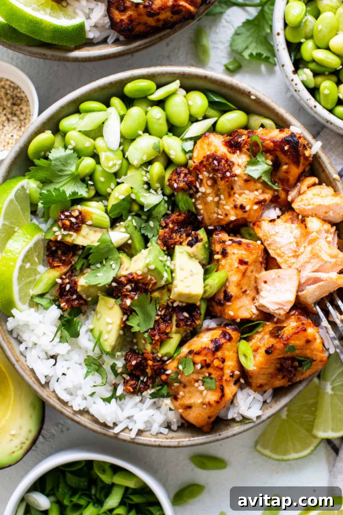 a bowl of chicken, rice, peas, and limes.