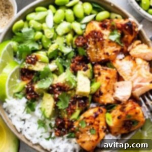a bowl filled with chicken, rice and vegetables.