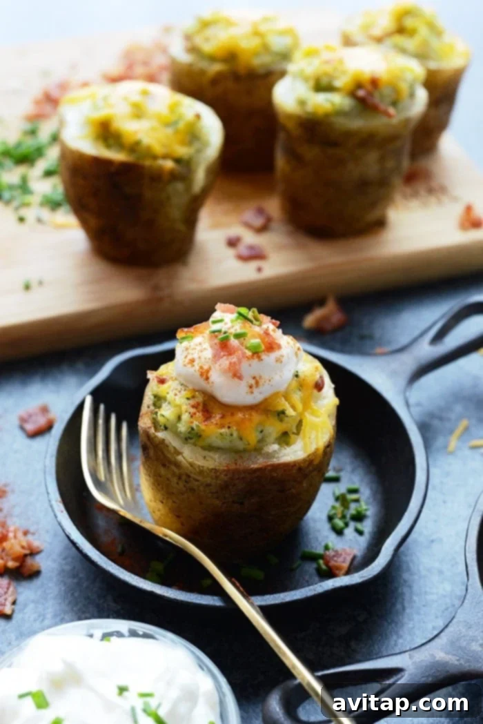 Delicious Lightened Up Broccoli Cheddar Twice Baked Potatoes, garnished and ready to be served on a festive table.