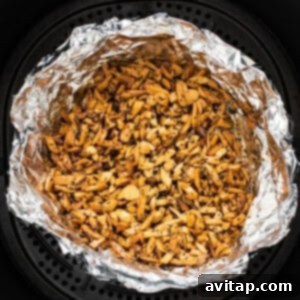 Crunchy Air Fried Brussels Salad 10 An air fryer filled with nuts.
