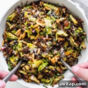 Crunchy Air Fried Brussels Salad 11 Brussels sprouts salad in a bowl with two forks.