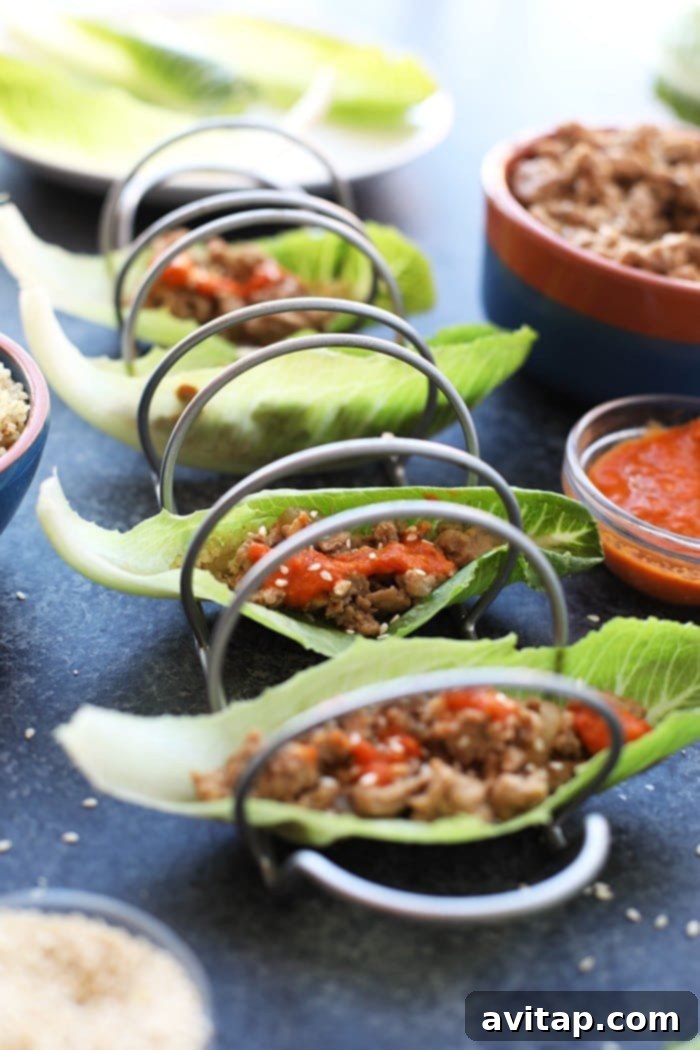 Korean Style Chicken Lettuce Wraps: A Healthy & Flavorful Weeknight Dinner Delicious Korean Style Chicken Lettuce Wraps in a taco holder, ready to be served for a healthy meal.