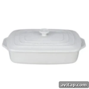 Cozy Butternut Quinoa Sausage Bake 3 A pristine white casserole dish, perfect for baking and serving delicious meals.