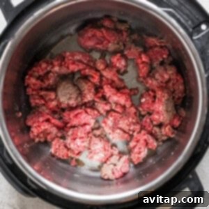 An instant pot with meat in it.