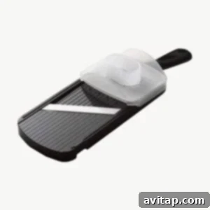 A high-quality mandoline slicer on a clean background, essential for uniformly thin potato slices.