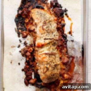 A perfectly golden-brown roasted turkey roulade on a baking sheet, fresh from the oven.