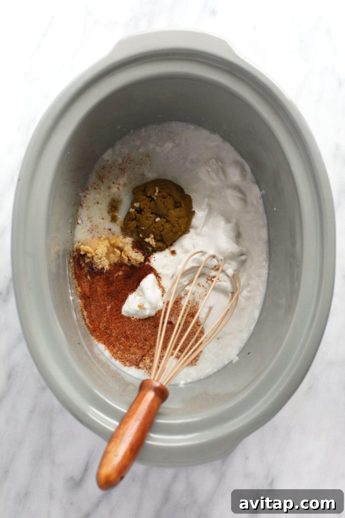 Aromatic Coconut Curry Chicken 4 All the vibrant ingredients for coconut curry chicken mixed in a slow cooker, ready for cooking.