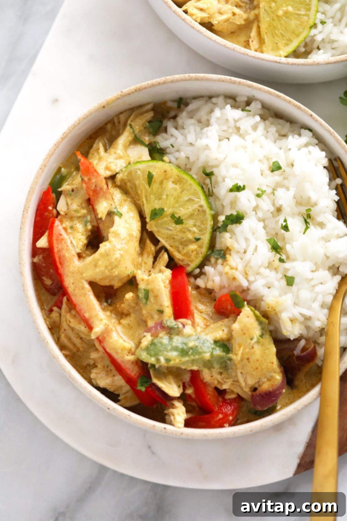 Aromatic Coconut Curry Chicken 9 A perfectly portioned bowl of coconut curry chicken with rice, ready to be enjoyed.