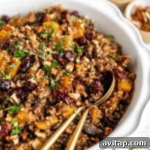 A beautifully presented bowl of Quinoa Stuffing, rich with cranberries, nuts, and herbs.