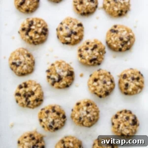 Chocolate chip cookies arranged on a baking sheet before going into the oven.