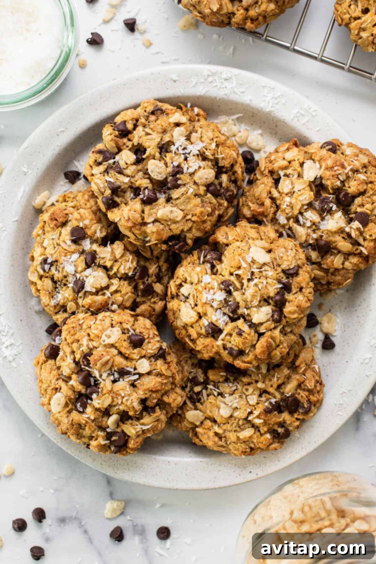 A plate of warm chocolate chip oatmeal cookies, ready to be enjoyed.