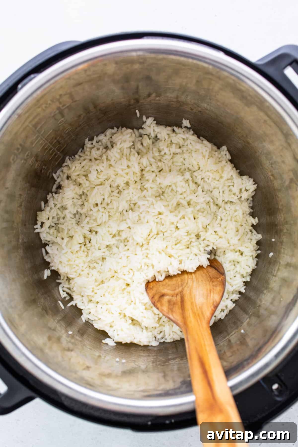 Freshly fluffed white rice inside an Instant Pot, showing its perfect texture and readiness to serve.