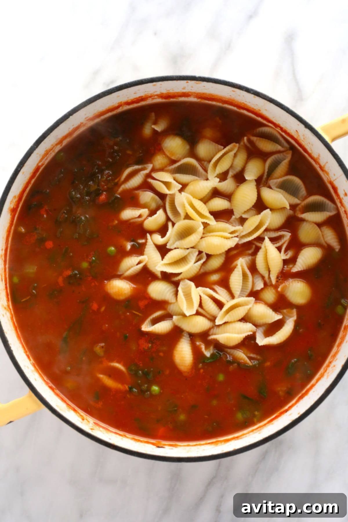 Make this vegetable packed minestrone soup and eat it all week long! Hearty shell noodles mixed into a rich minestrone soup, ready to be served.