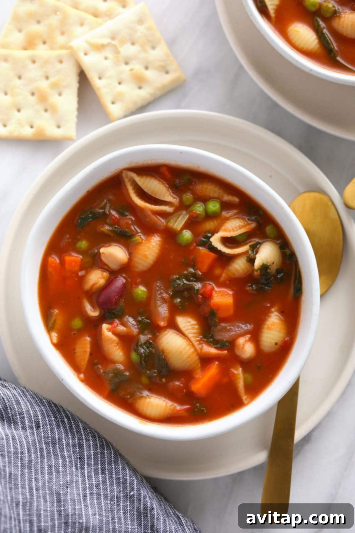 Make this vegetable packed minestrone soup and eat it all week long! A beautifully presented bowl of minestrone soup, perfect for sharing at a family dinner.