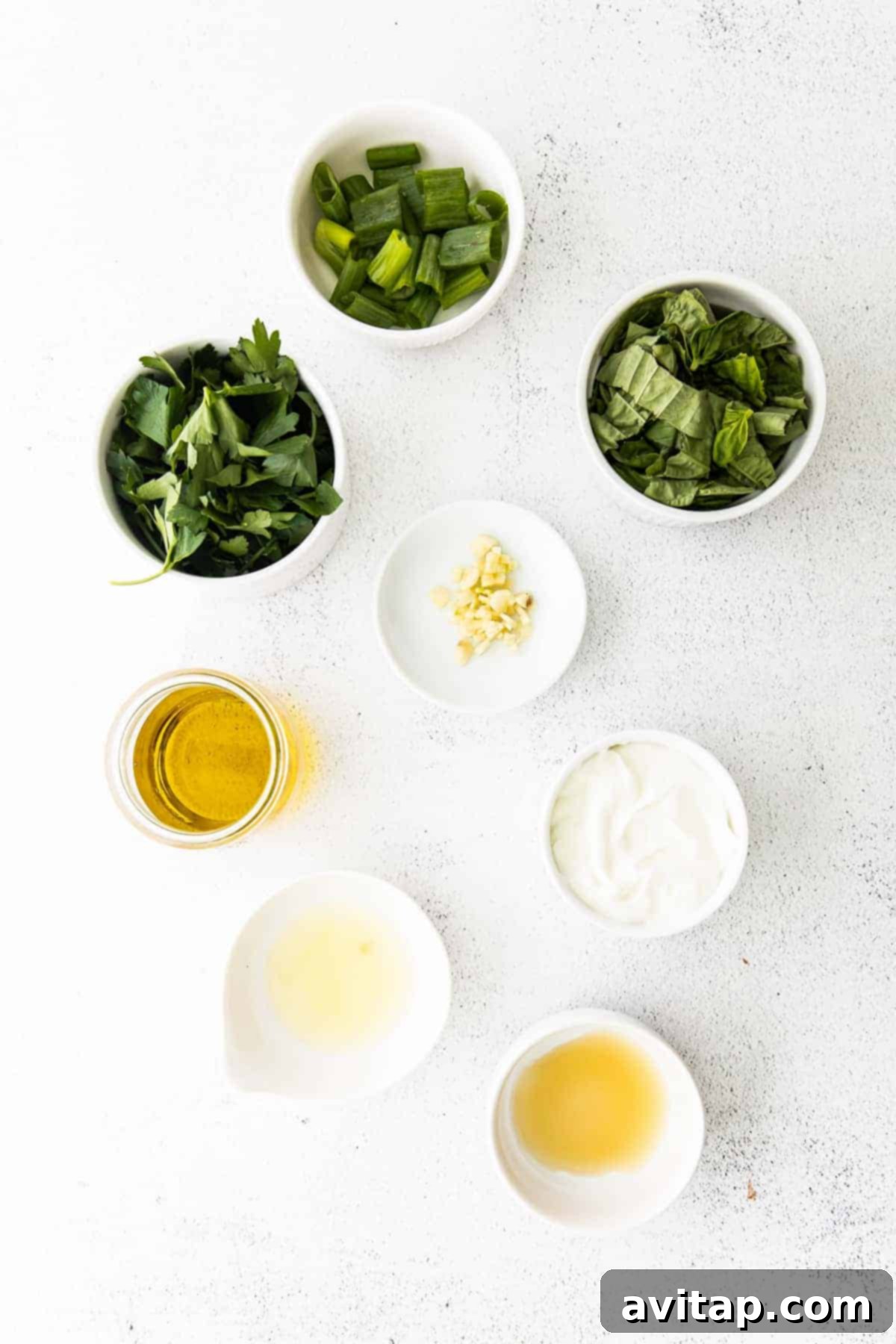 Freshly prepared Green Goddess Dressing resting on a clean kitchen countertop.