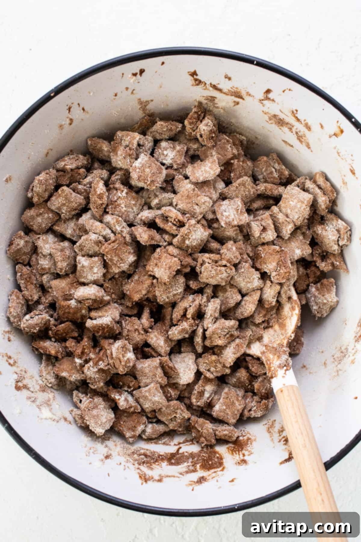 A large bowl filled with delicious protein puppy chow, highlighting its evenly coated clusters and inviting texture.