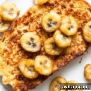 French toast with banana slices on a plate, ready to be served and enjoyed.