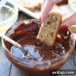 Gluten-Free Almond Biscotti 7 Dipping an almond flour biscotti into melted chocolate.