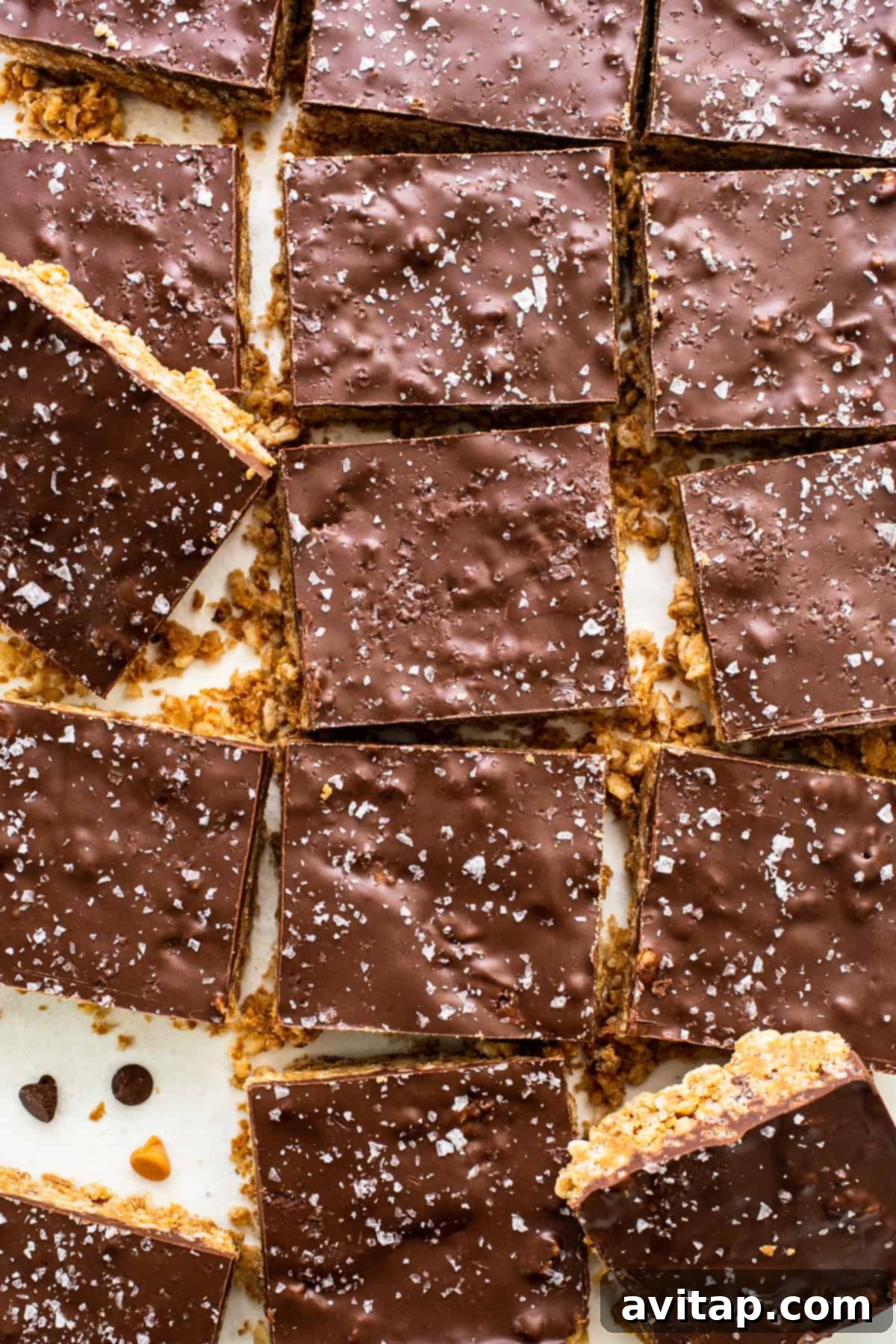 A sheet of perfectly cut chocolate bars on a white plate, showcasing delicious protein scotcheroos.