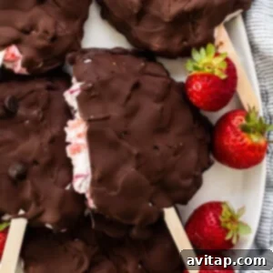 Finished chocolate covered strawberry frozen yogurt bars on a plate, ready to be served.