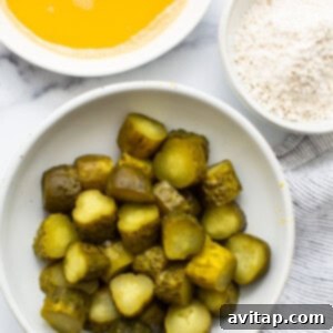 A bowl of pickles and a bowl of flour.