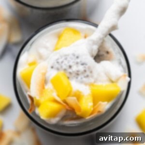 A bowl of mango and coconut yogurt with a spoon, similar to the chia pudding texture.