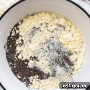 A bowl of ingredients in a pan with a wooden spoon, indicating the start of mixing.