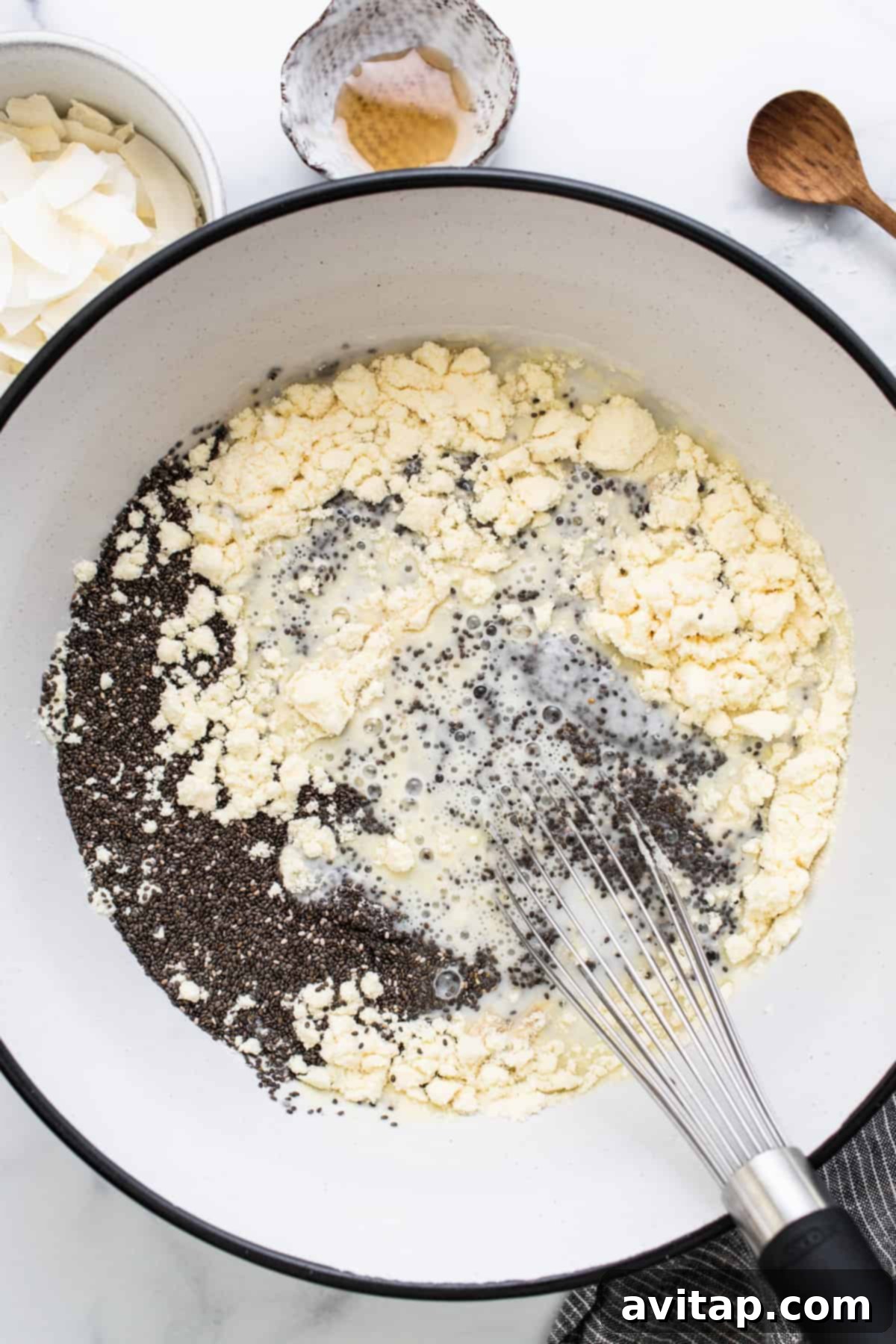 A bowl of ingredients in a pan with a wooden spoon, showcasing the rich texture before chilling.