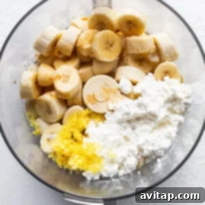 A bowl of food with bananas and cottage cheese, ready to be blended.