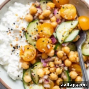 A serving of chickpea, cucumber, and cottage cheese salad in a bowl.