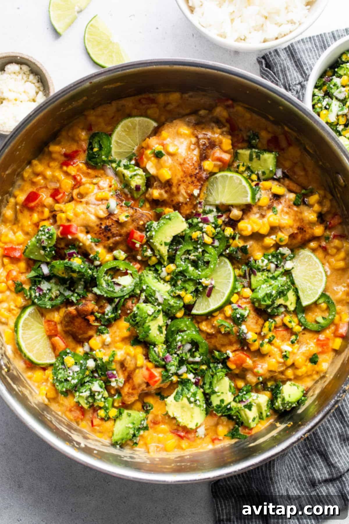A bowl of chicken curry with vegetables and rice.
