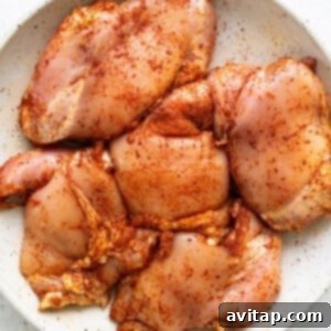 Chicken breasts in a white plate on a white background.