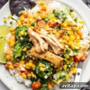 A white plate with chicken and vegetables on it.