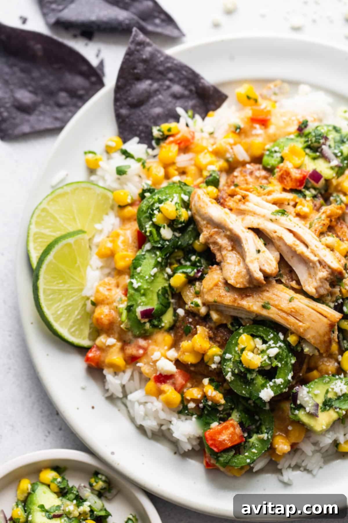 A white plate with chicken and vegetables on it.