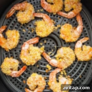 Fried shrimp in an air fryer with sesame seeds.