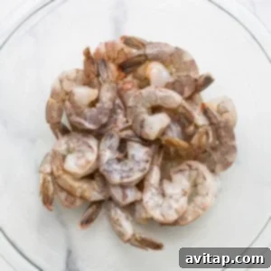 Shrimp in a glass bowl on a marble table.