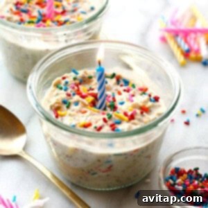 A birthday cake in a jar with a candle and sprinkles, representing a joyful breakfast.