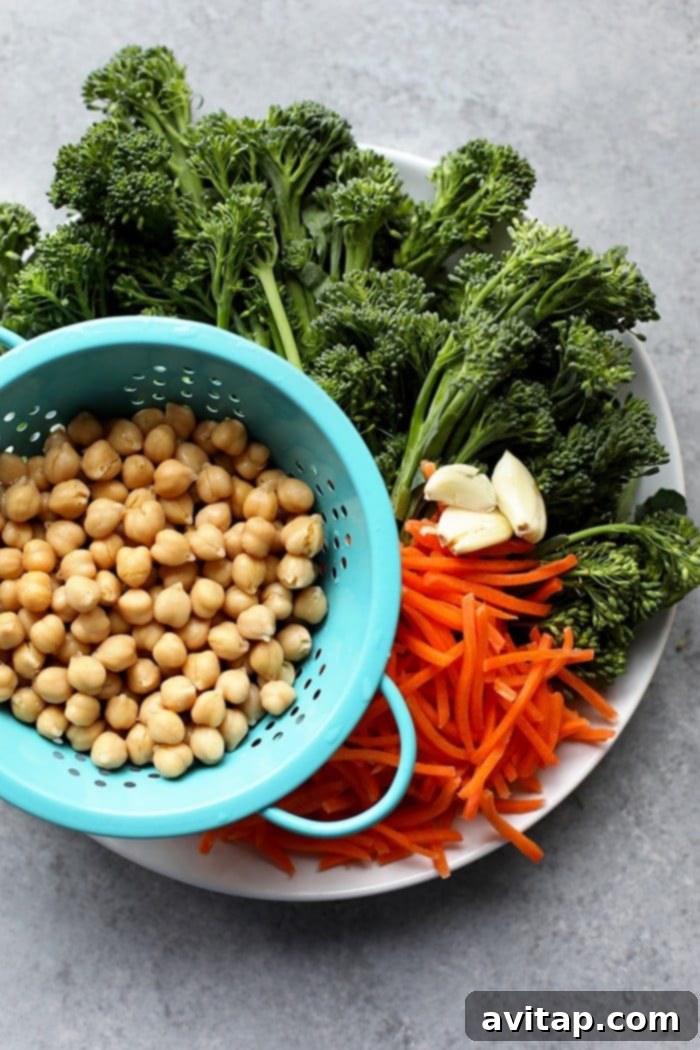 Close-up of a Vegetarian Kung Pao Quinoa Bowl, showcasing the vibrant green dressing cascading over fresh vegetables and fluffy quinoa, ready to be enjoyed.