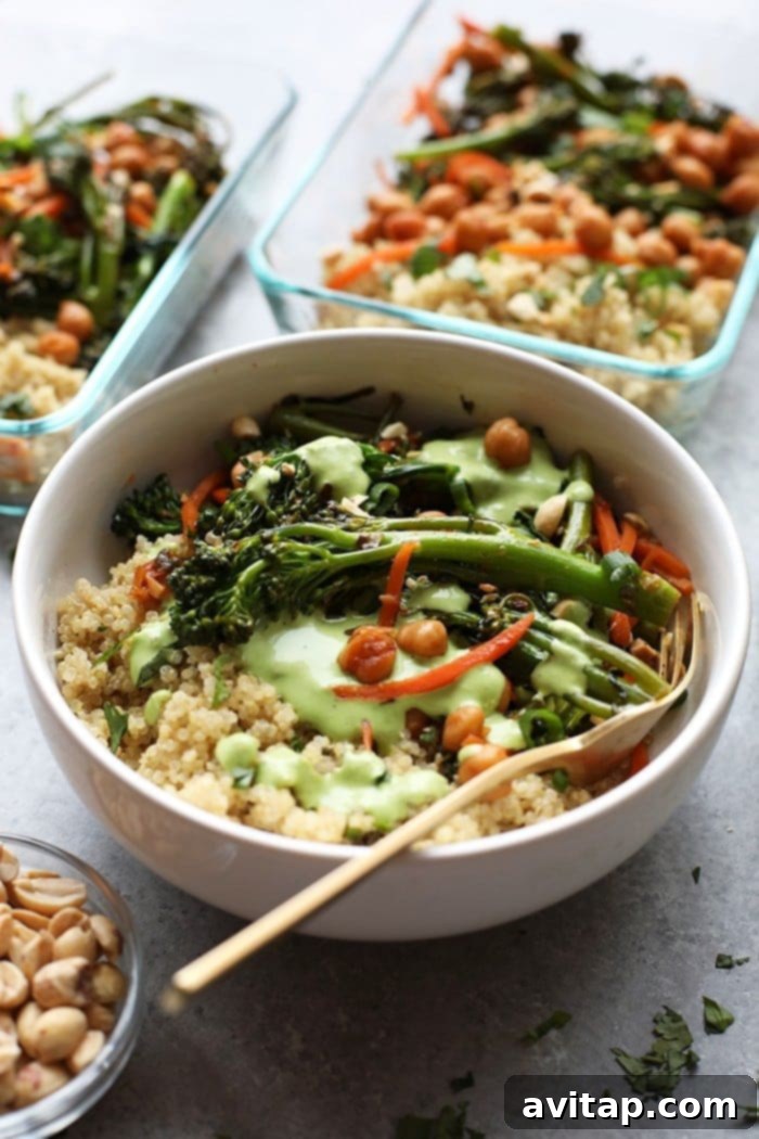 Overhead view of a ready-to-eat Vegetarian Kung Pao Quinoa Bowl, beautifully garnished with peanuts, sesame seeds, and green onions, accompanied by a side of green goddess dressing.