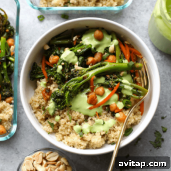 A beautifully presented bowl of quinoa, broccoli, chickpeas, and fresh greens, drizzled with a vibrant green dressing – a visual representation of the Kung Pao Quinoa Bowl recipe.