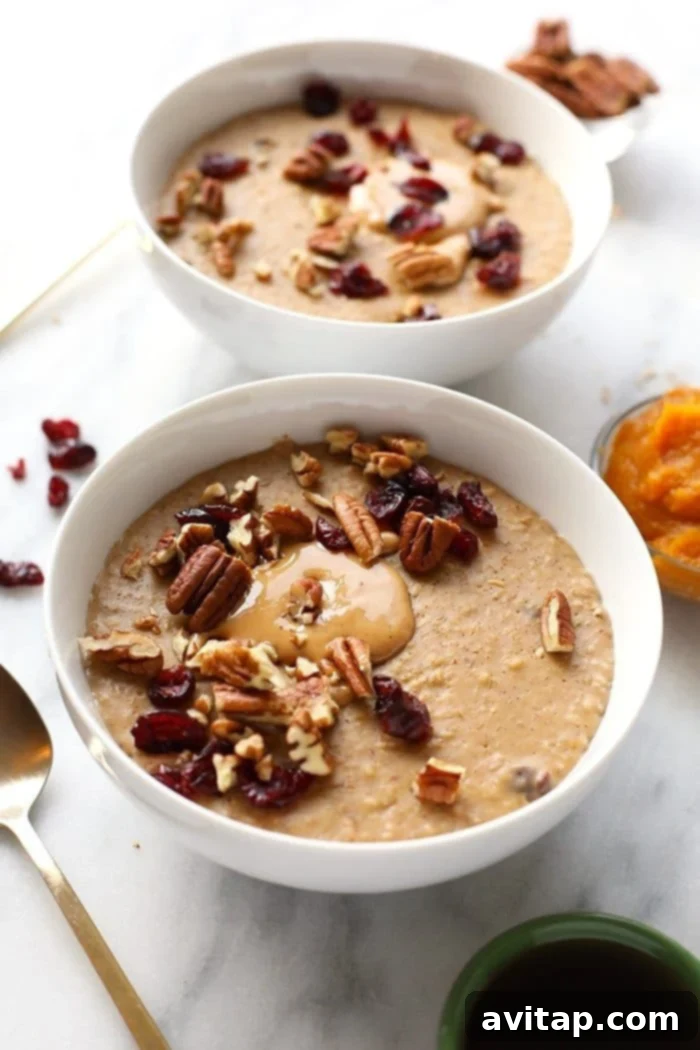 A large serving of Slow Cooker Pumpkin Oatmeal, perfectly cooked and ready for toppings, showcasing its creamy texture and rich autumnal color.