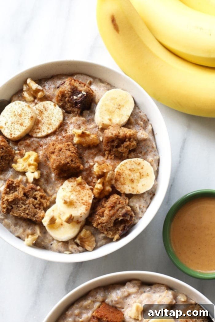 A beautifully presented bowl of banana oatmeal, garnished with fresh banana slices and a sprinkle of cinnamon.
