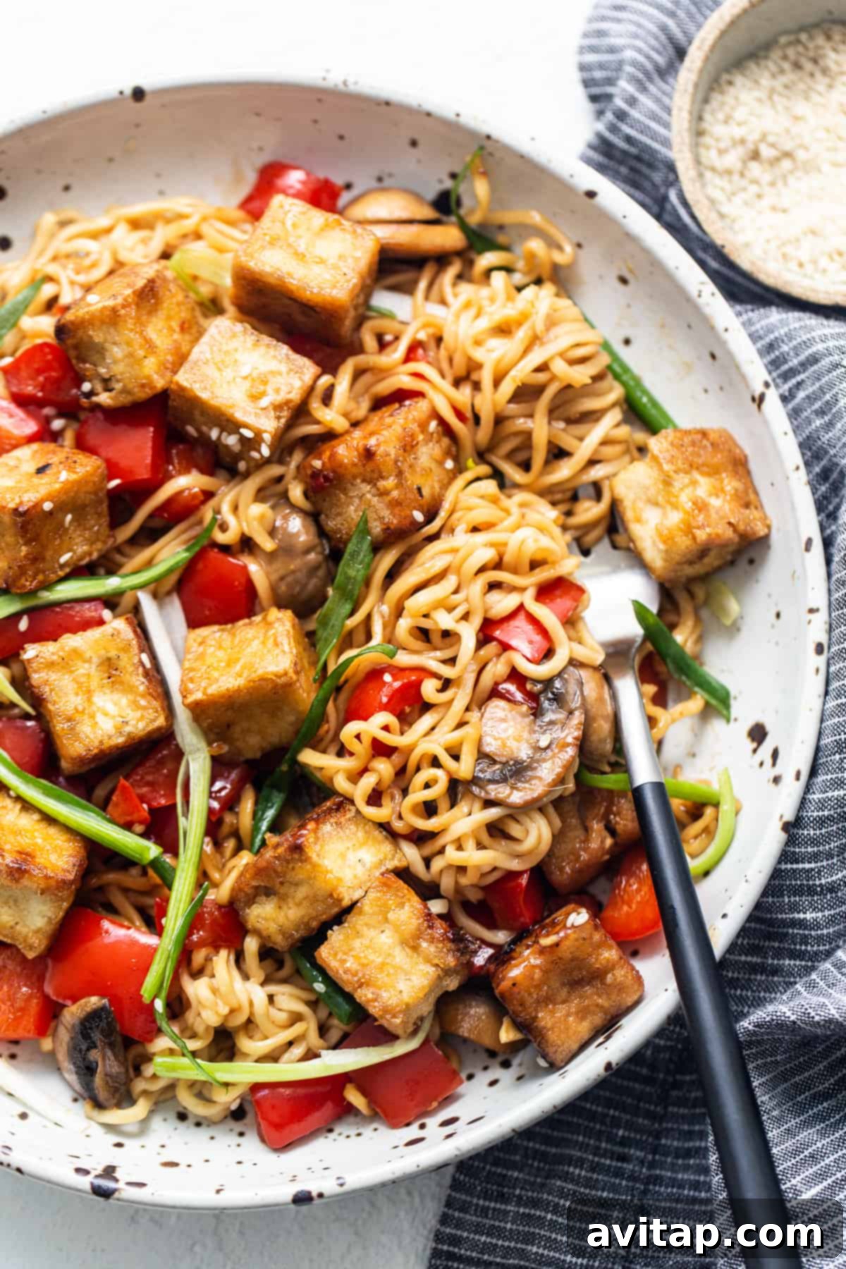Tofu stir fry in a pan with mushrooms and vegetables, ready to be served.