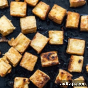 Cooking tofu cubes to golden perfection in a hot pan.