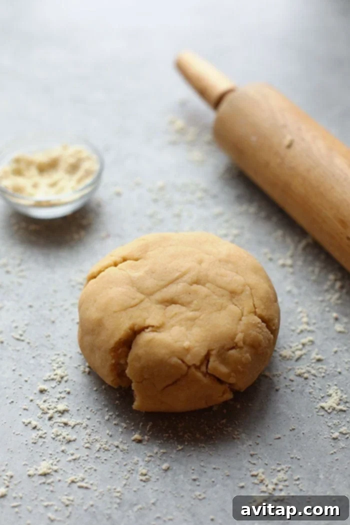 Expertly rolling out gluten-free sugar cookie dough for precise cuts Rolling out gluten-free sugar cookie dough
