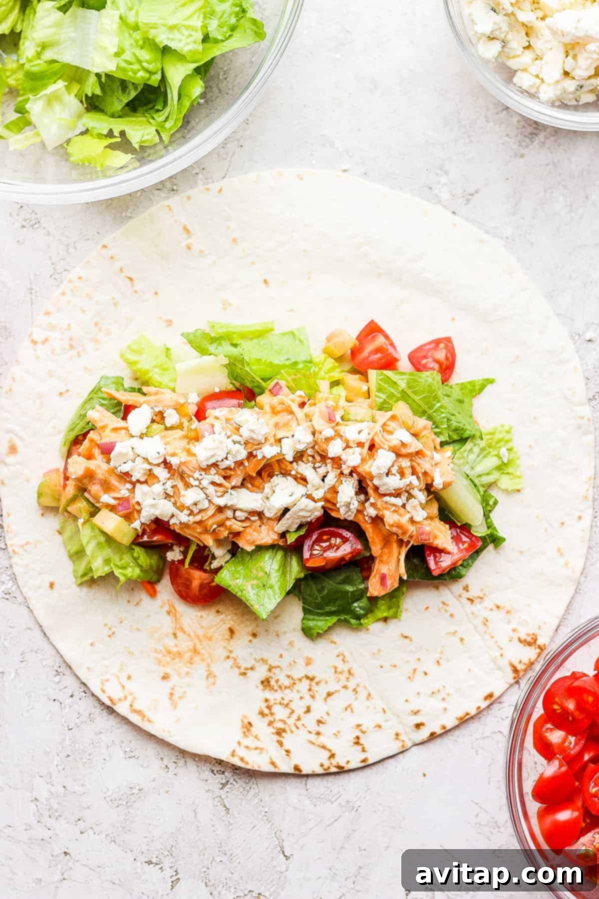 A perfectly rolled Buffalo Chicken Wrap, showcasing the golden tortilla and a hint of the colorful filling inside