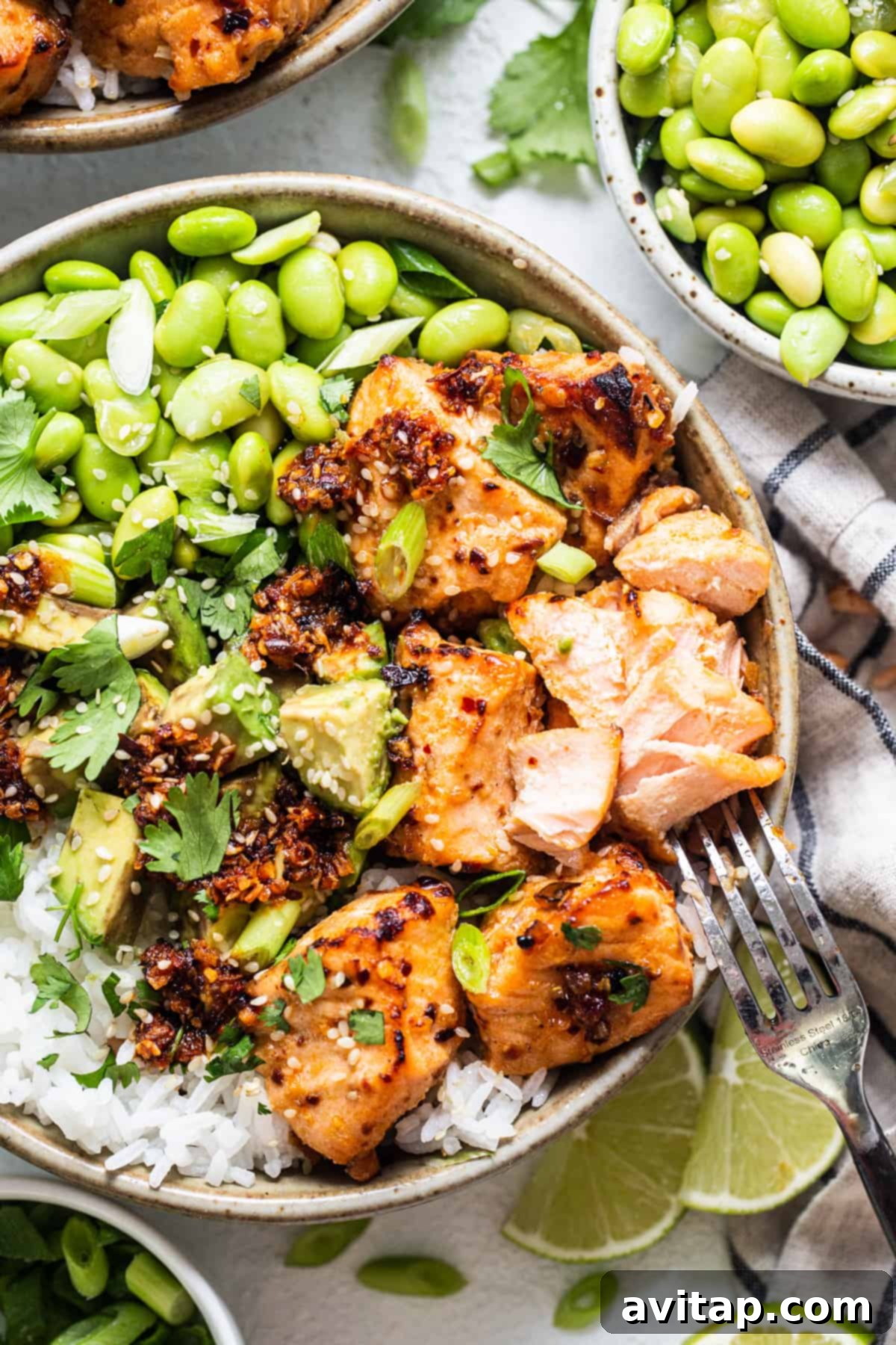 a bowl filled with chicken, peas, and rice.